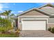 Charming single-Gathering home with a two-car garage, a brick driveway, and well-manicured landscaping at 6224 Timberdale Ave, Wesley Chapel, FL 33545
