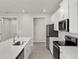 Bright kitchen featuring white cabinets, stainless steel appliances, and a modern island at 6224 Timberdale Ave, Wesley Chapel, FL 33545
