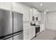 Bright kitchen featuring white cabinets, stainless steel appliances, and quartz countertops at 6224 Timberdale Ave, Wesley Chapel, FL 33545