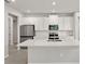 Bright kitchen featuring white cabinets, stainless steel appliances, and a modern island at 6224 Timberdale Ave, Wesley Chapel, FL 33545