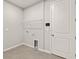 Laundry room featuring tile flooring, utility connections, and a wire shelf at 6224 Timberdale Ave, Wesley Chapel, FL 33545