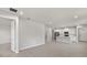 Open-concept living space with tile floors and recessed lighting, seamlessly flowing into the kitchen at 6224 Timberdale Ave, Wesley Chapel, FL 33545