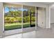 An enclosed patio features stone flooring and beautiful green outdoors views at 6224 Timberdale Ave, Wesley Chapel, FL 33545