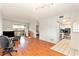 Bright living room featuring hardwood floors, a sliding glass door, and a view into the adjacent kitchen at 6328 Newtown Cir # 28B3, Tampa, FL 33615