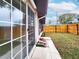 View of the house with a large sliding glass door and a newly constructed wooden fence at 6718 Ranchwood Loop, New Port Richey, FL 34653
