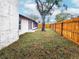 Backyard featuring a newly constructed wooden fence and a mature shade tree at 6718 Ranchwood Loop, New Port Richey, FL 34653