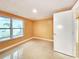 Bright bedroom featuring a large window, tile flooring, and fresh neutral paint at 6718 Ranchwood Loop, New Port Richey, FL 34653