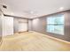 Bright bedroom with a large window and closet space, providing natural light at 6718 Ranchwood Loop, New Port Richey, FL 34653