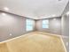 Bedroom with carpet flooring, ceiling fan, and two bright windows at 6718 Ranchwood Loop, New Port Richey, FL 34653