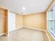 Inviting bedroom showcases tile flooring, neutral paint, and closet with ample storage at 6718 Ranchwood Loop, New Port Richey, FL 34653