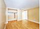 Spacious bedroom highlights hardwood floors, closet, and neutral paint, perfect for relaxation at 6718 Ranchwood Loop, New Port Richey, FL 34653
