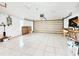 Spacious garage with tile flooring and plenty of space for storage and projects at 6718 Ranchwood Loop, New Port Richey, FL 34653