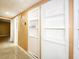 This hallway features tile floors, fresh paint, and large built-in shelving units at 6718 Ranchwood Loop, New Port Richey, FL 34653