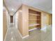 Hallway features tile flooring, shelving, and access to several rooms at 6718 Ranchwood Loop, New Port Richey, FL 34653