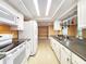 Bright kitchen features white appliances, cabinetry, countertops, and stainless steel sink at 6718 Ranchwood Loop, New Port Richey, FL 34653