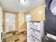 Functional laundry room with tile flooring, utility sink, and built-in shelving for storage at 6718 Ranchwood Loop, New Port Richey, FL 34653