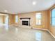 Cozy living room with large windows offering plenty of natural light and fireplace at 6718 Ranchwood Loop, New Port Richey, FL 34653