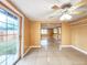 Bright living area with sliding glass doors and a ceiling fan at 6718 Ranchwood Loop, New Port Richey, FL 34653