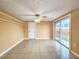 Spacious living room with tile flooring, ceiling fan, and sliding glass doors to the yard at 6718 Ranchwood Loop, New Port Richey, FL 34653