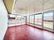 Enclosed sun room featuring windows, bright interior, access door, and painted concrete floors at 6718 Ranchwood Loop, New Port Richey, FL 34653