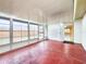 Spacious sunroom with red floors and lots of light from the many surrounding windows at 6718 Ranchwood Loop, New Port Richey, FL 34653