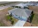 An aerial view shows the property with landscaping, driveway, and front-facing garage at 702 W Brockton Pl # 2, Sun City Center, FL 33573