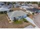 A bird's-eye view displays the home with its front-facing garage, landscaping, and driveway at 702 W Brockton Pl # 2, Sun City Center, FL 33573