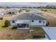 An aerial view of the property with its screened in patio and the grassy lawn at 702 W Brockton Pl # 2, Sun City Center, FL 33573