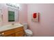 Cozy half bathroom featuring a decorative mirror and vanity sink at 702 W Brockton Pl # 2, Sun City Center, FL 33573
