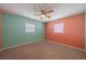 Inviting bedroom with plush carpeting, two windows, and a ceiling fan at 702 W Brockton Pl # 2, Sun City Center, FL 33573