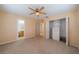 Carpeted bedroom with a ceiling fan, spacious closet, and ensuite bathroom at 702 W Brockton Pl # 2, Sun City Center, FL 33573