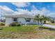 Charming single-story home with neat front lawn, accent palm tree, and a lovely blue sky at 702 W Brockton Pl # 2, Sun City Center, FL 33573