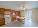 Eat-in kitchen features a dining table, wood cabinets, and a sliding glass door at 702 W Brockton Pl # 2, Sun City Center, FL 33573