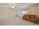 Living room featuring tile flooring, a ceiling fan, and natural light at 702 W Brockton Pl # 2, Sun City Center, FL 33573
