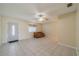 Spacious living room featuring tile flooring, a ceiling fan, and natural light at 702 W Brockton Pl # 2, Sun City Center, FL 33573