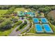 Aerial community view showcasing the pool, tennis courts, and lush surroundings at 8208 Pinewood Run Ct, Tampa, FL 33647