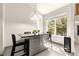 Bright kitchen with stainless steel island, modern lighting fixture, and large windows at 8208 Pinewood Run Ct, Tampa, FL 33647