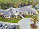 An aerial view of a beautiful clubhouse surrounded by lush landscaping and palm trees at 10115 Whisper Pointe Dr, Tampa, FL 33647