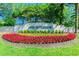 The community entrance sign is surrounded by a beautiful display of colorful flowerbeds and greenery at 10115 Whisper Pointe Dr, Tampa, FL 33647