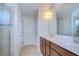 This bathroom features a double vanity, tile flooring, and a glass shower at 11117 Abaco Island Ave, Riverview, FL 33579