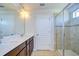 This bathroom features a double vanity, tile flooring, and a glass shower at 11117 Abaco Island Ave, Riverview, FL 33579