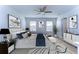 This primary bedroom features a ceiling fan, natural light, ensuite bathroom, and neutral decor at 11117 Abaco Island Ave, Riverview, FL 33579