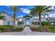 This community entrance features palm trees, green space, and a sidewalk at 11117 Abaco Island Ave, Riverview, FL 33579