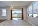 Bright dining area with tile floors, chandelier, and sliding glass doors to the backyard at 11117 Abaco Island Ave, Riverview, FL 33579
