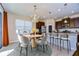 Dining area featuring a modern chandelier, and seamless access to the kitchen island and stainless appliances at 11117 Abaco Island Ave, Riverview, FL 33579