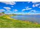 Breathtaking view of the lake, showcasing the expansive water, green shoreline, and charming neighborhood backdrop at 11117 Abaco Island Ave, Riverview, FL 33579