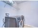 Laundry room with washer, dryer, and storage shelf at 11117 Abaco Island Ave, Riverview, FL 33579