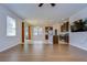 Spacious living area featuring hardwood floors, a large window, and an open layout with easy access to the kitchen at 11117 Abaco Island Ave, Riverview, FL 33579