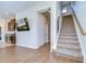 Living room features hardwood floors, staircase, and kitchen with stainless steel appliances at 11117 Abaco Island Ave, Riverview, FL 33579