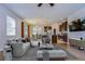 Open-concept living room with modern furniture, a large window, and seamless access to the dining area and kitchen at 11117 Abaco Island Ave, Riverview, FL 33579